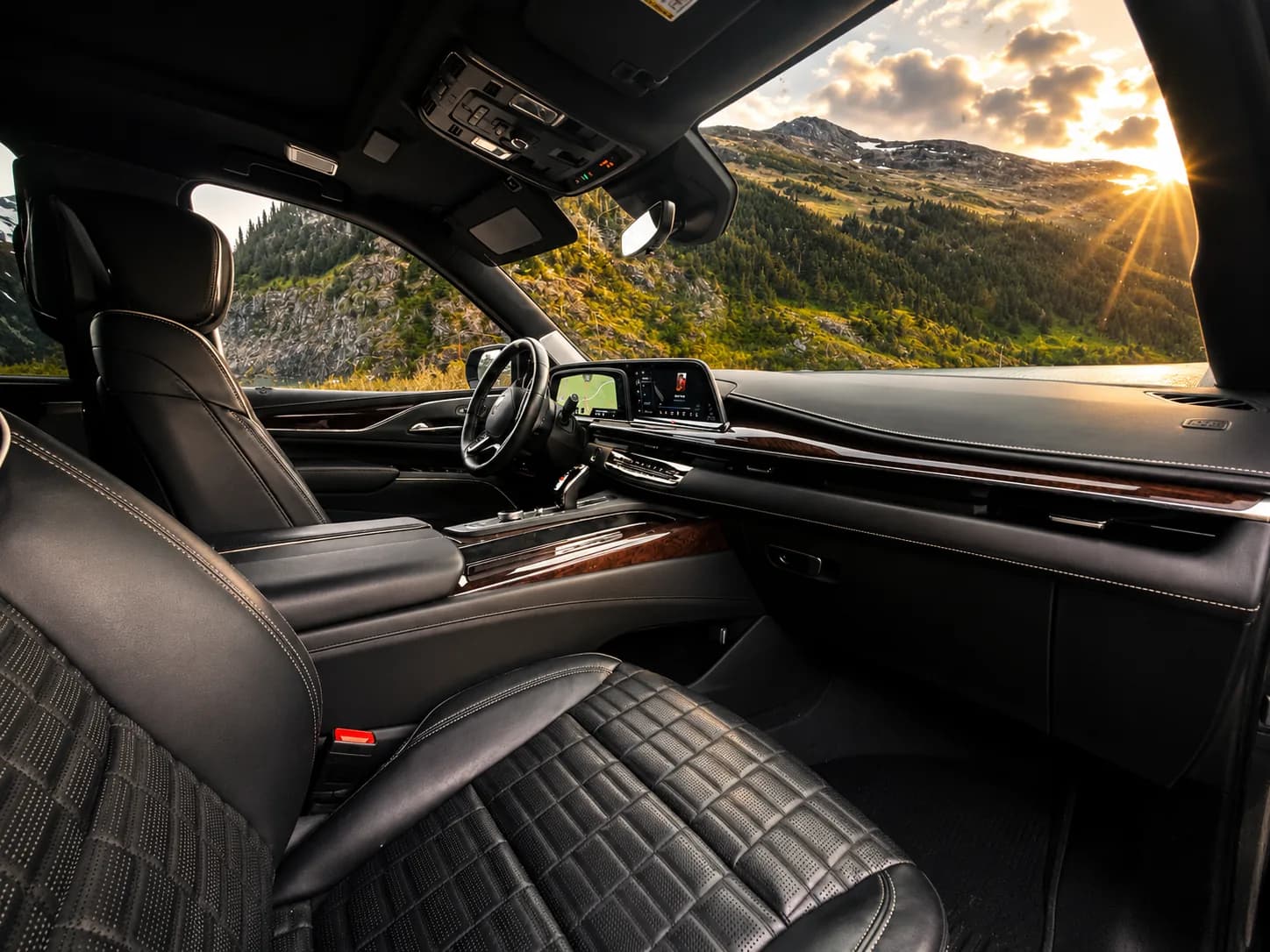 Front cabin of the Cadillac Escalade with leather, wood trim and a curved display