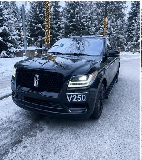 The Lincoln Navigator on a snowy road through the spruce, Southcentral Alaska